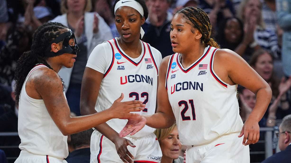 UConn's KK Arnold, left, Serah Williams (22) and Sarah Strong (21) celebrate late in the second half in the Sweet 16 of the NCAA college basketball tournament against North Carolina, Friday, March 27, 2026, in Fort Worth, Texas.