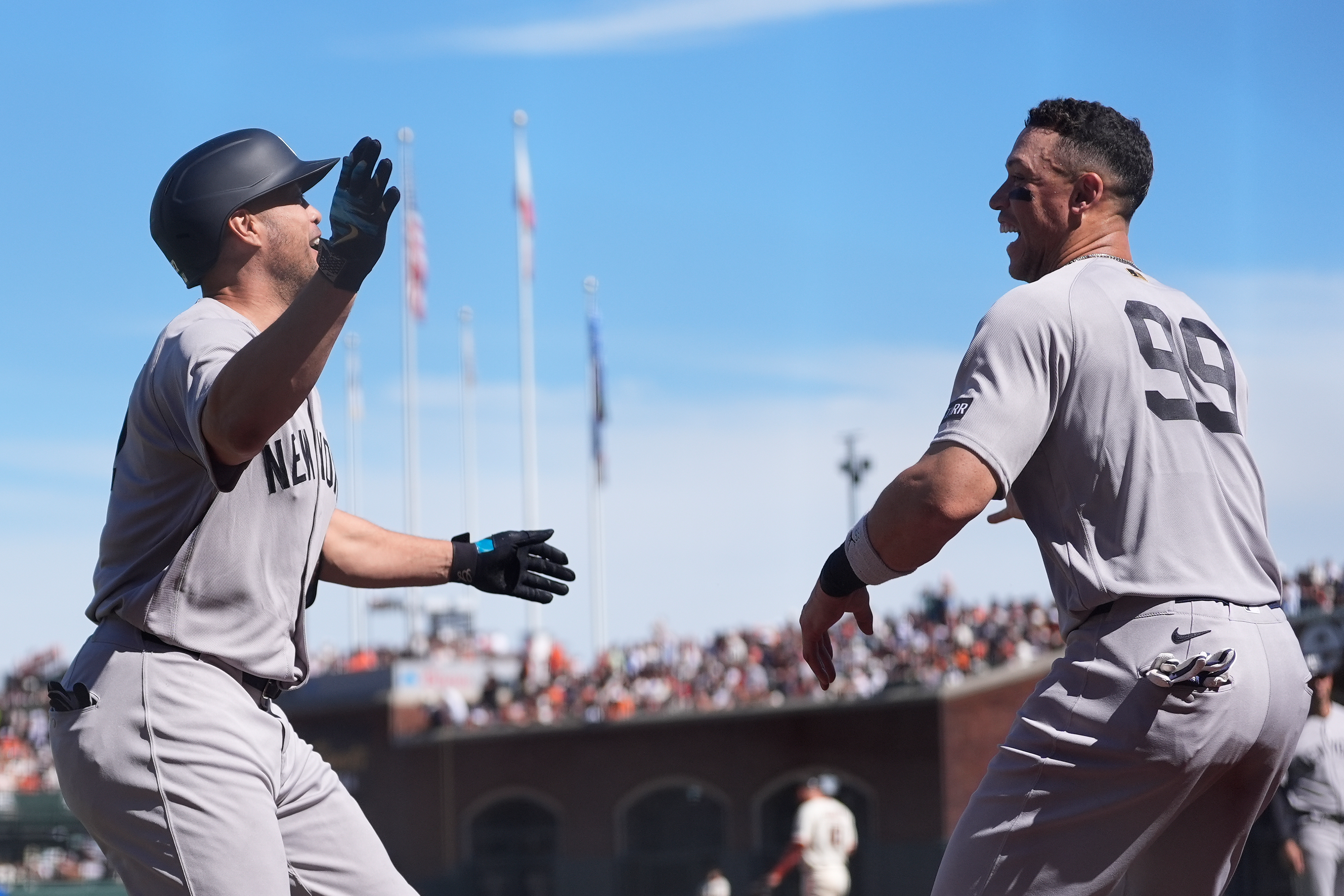 New York Yankees' Giancarlo Stanton, left, is congratulated by Aaron Judge after hitting a home run during the sixth inning of a baseball game against the San Francisco Giants in San Francisco, Friday, March 27, 2026. 