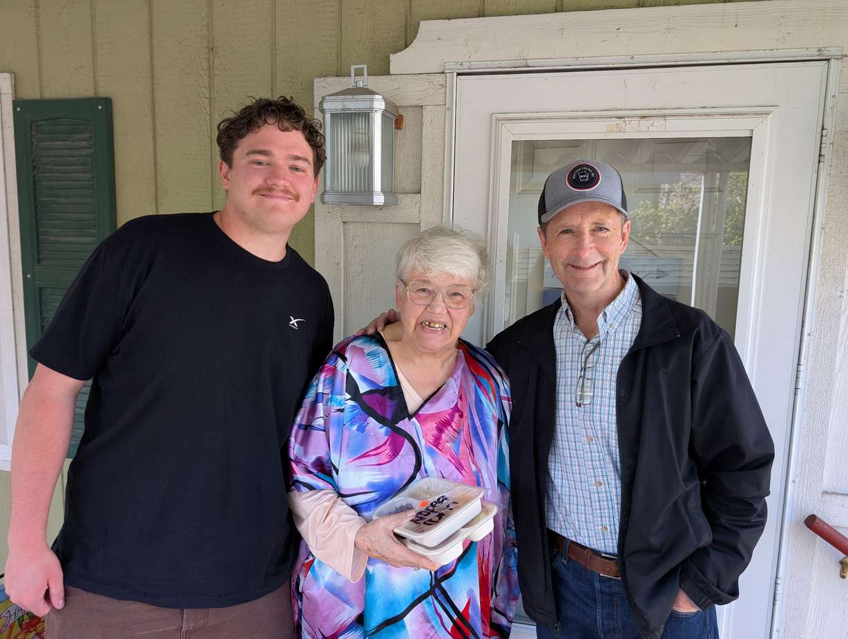 Springville Mayor Matt Packard (right) visits with a senior resident during a Meals on Wheels delivery on Tuesday, March 24.