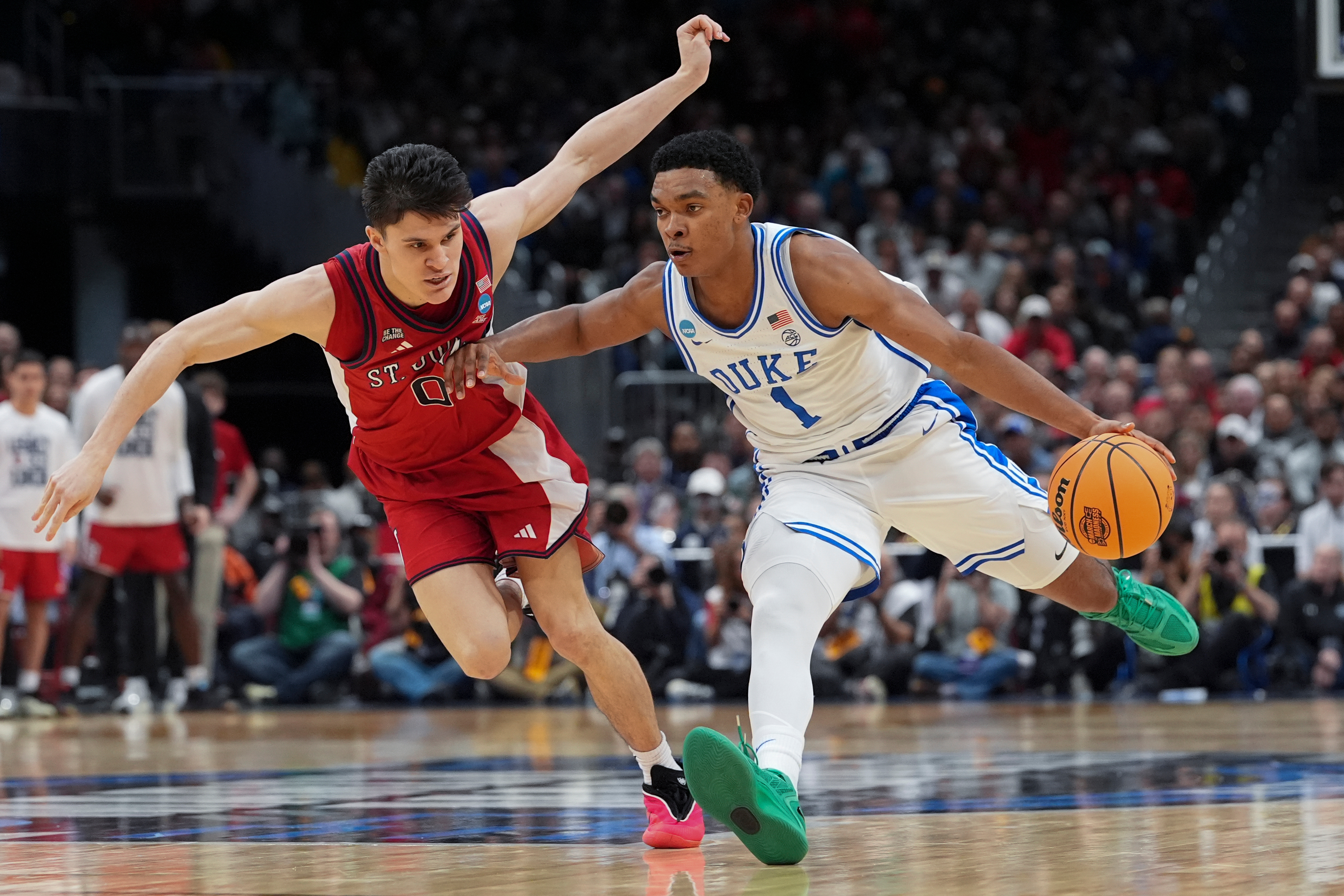 Duke guard Caleb Foster (1) drives past St. John's guard Dylan Darling (0) during the second half in the Sweet 16 of the NCAA college basketball tournament, Friday, March 27, 2026, in Washington. 