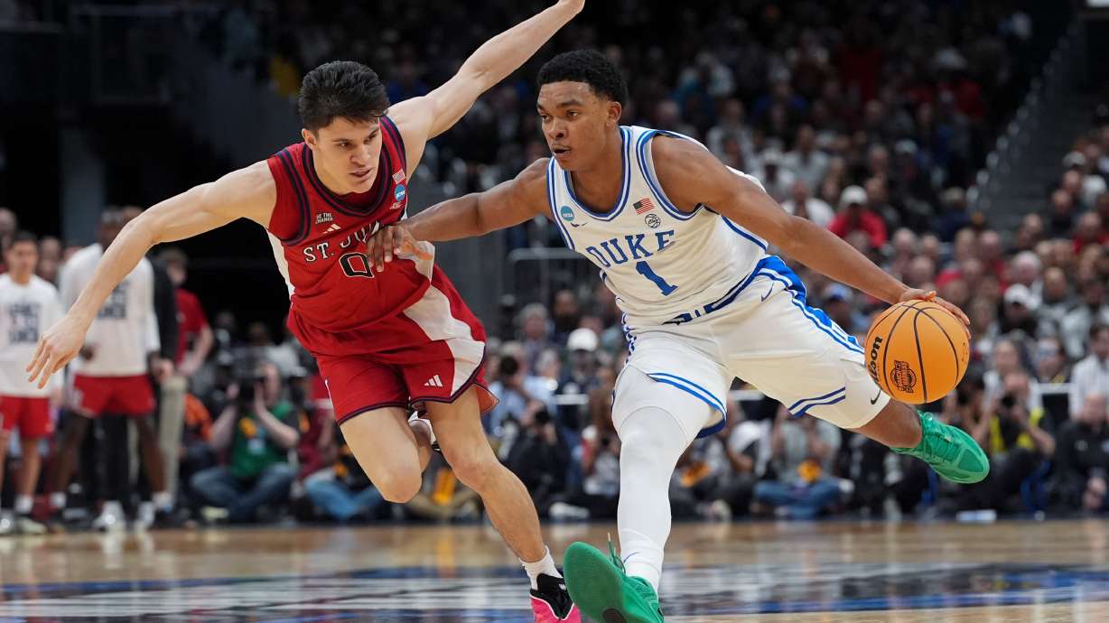Duke guard Caleb Foster (1) drives past St. John's guard Dylan Darling (0) during the second half in the Sweet 16 of the NCAA college basketball tournament, Friday, March 27, 2026, in Washington.