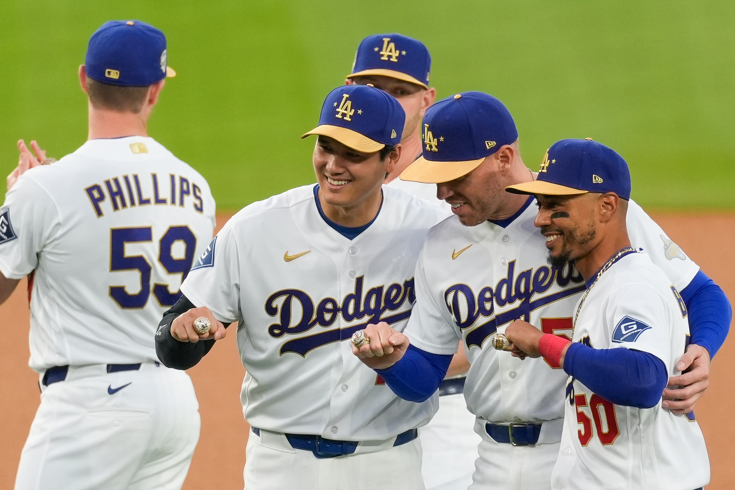 Los Angeles Dodgers Shohei Ohtani, Freddie Freeman and Mookie Betts pose with their rings during a World Series Champion ring ceremony prior to a baseball game against the Arizona Diamondbacks in Los Angeles, Friday, March 27, 2026. 