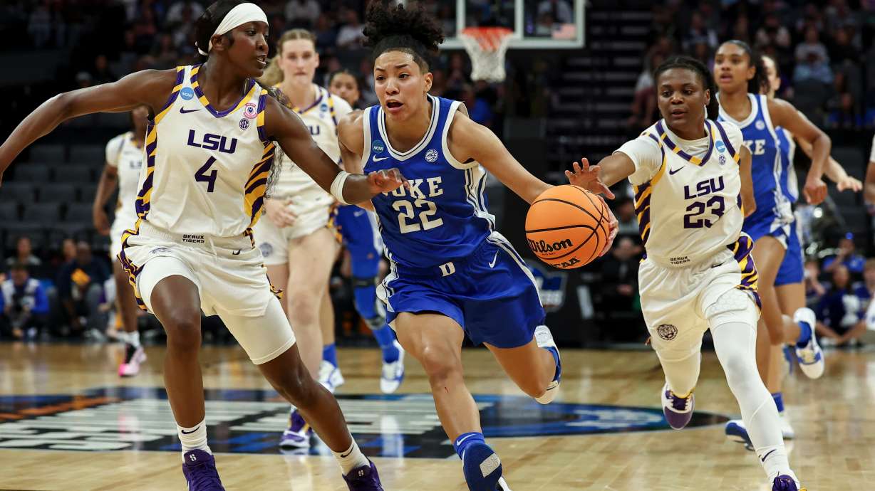 Duke guard Taina Mair (22) drives to the basket with LSU guards Flau'jae Johnson (4) and MiLaysia Fulwiley (23) defending during the first half in the Sweet 16 of the NCAA college basketball tournament Friday, March 27, 2026, in Sacramento, Calif.