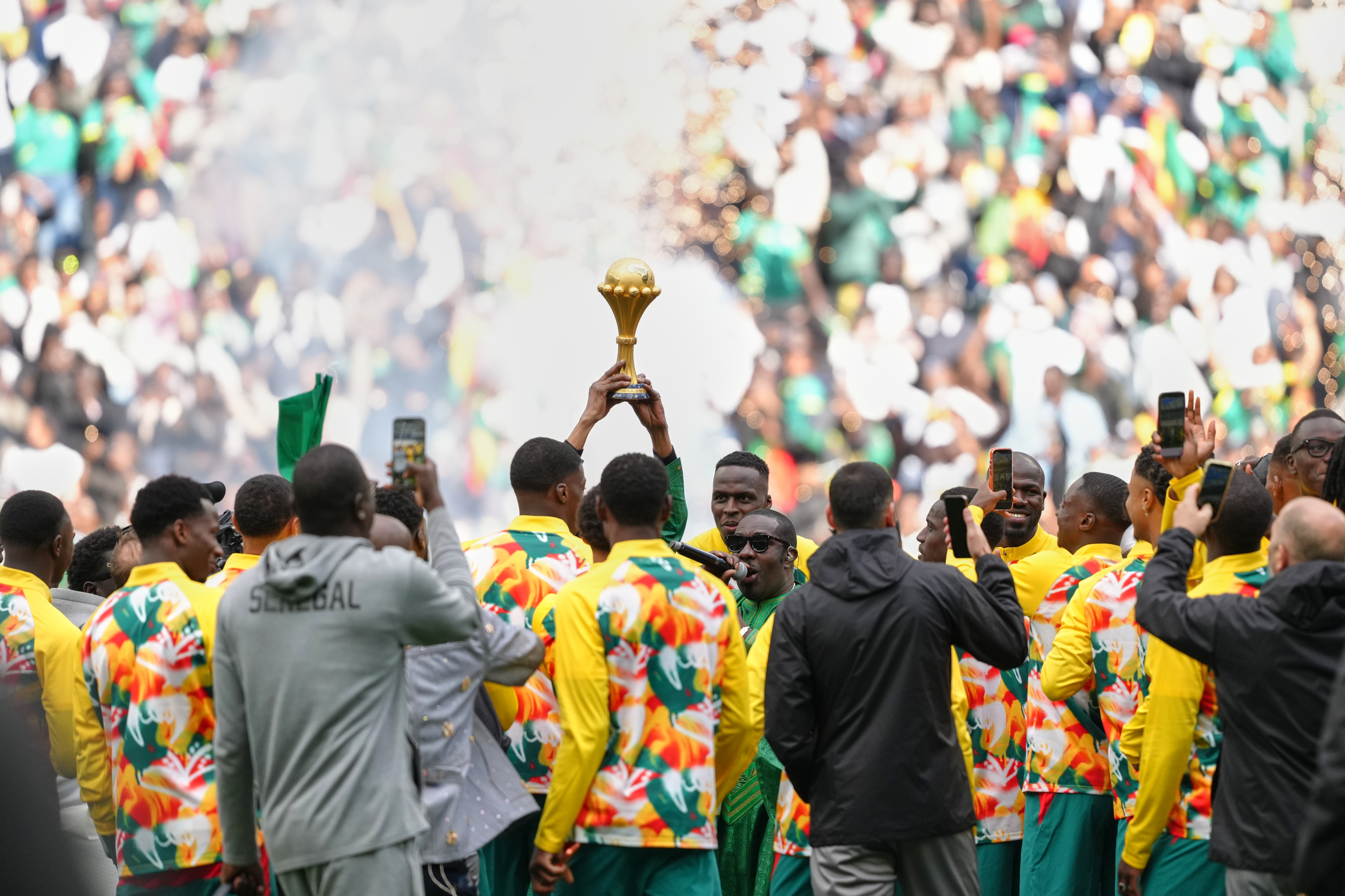 Senegal players celebrate with the Africa Cup of Nations trophy ahead of the international friendly soccer match between Senegal and Peru in Saint-Denis, outside of Paris, Saturday, March 28, 2026.