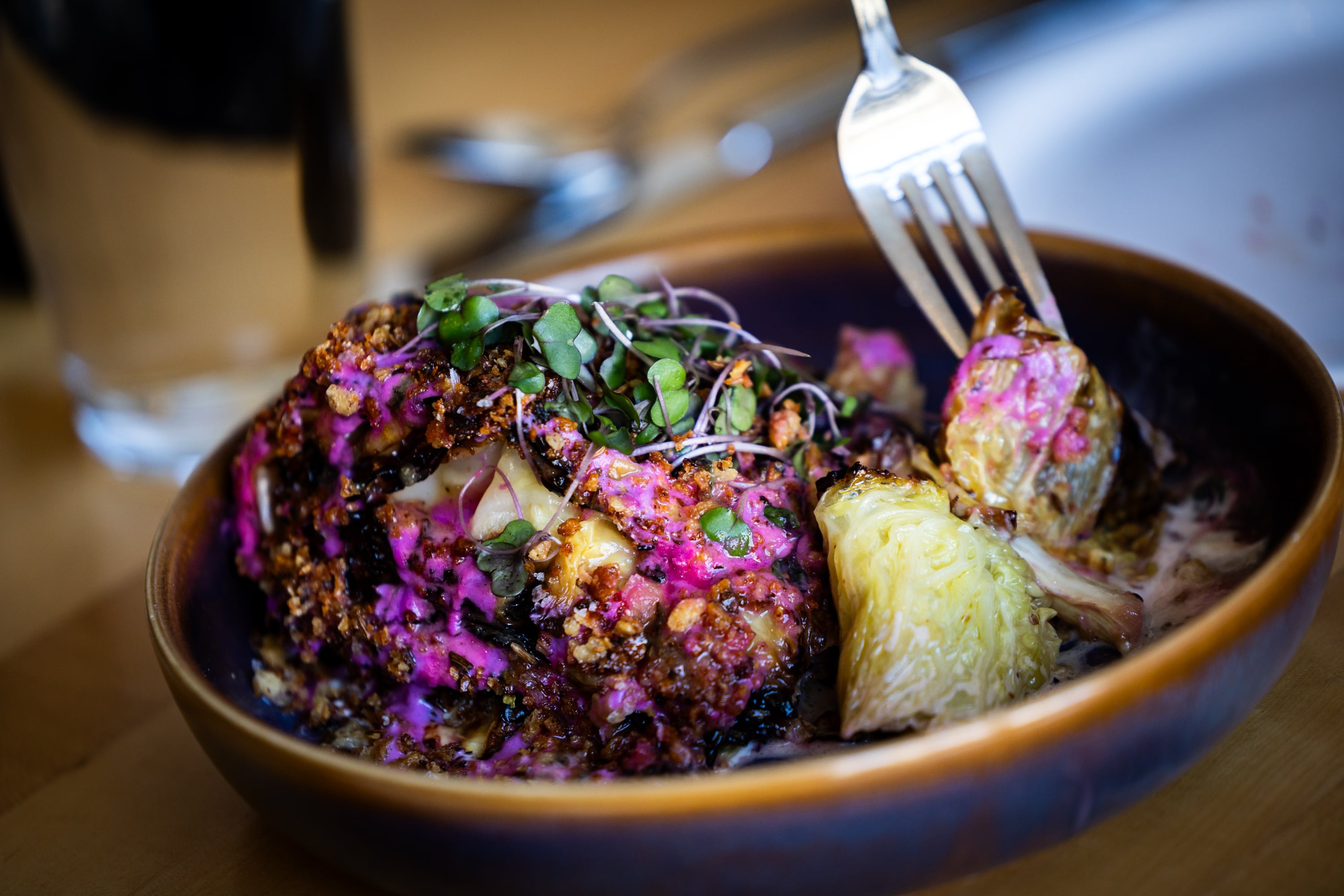 People eat charred savoy cabbage at Oquirrh Restaurant in Salt Lake City on Thursday. Owner Andrew Fuller said his first experience managing a kitchen was a pool grill at Mount Hood.
