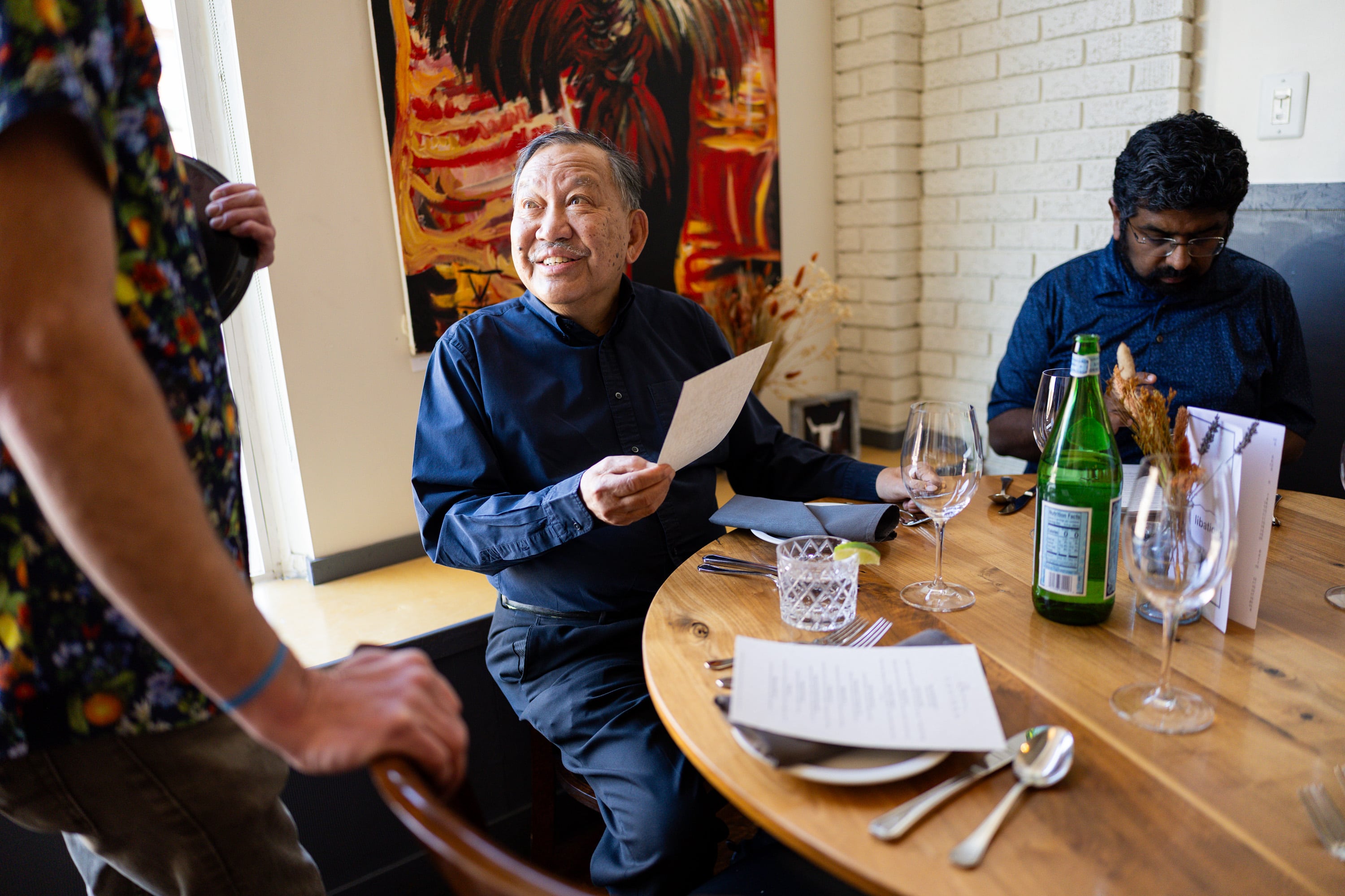 Toto Olivera orders food at Oquirrh Restaurant in Salt Lake City on March 19. Owner Andrew Fuller's wife, Angie, is in charge of the hospitality side of the restaurant.