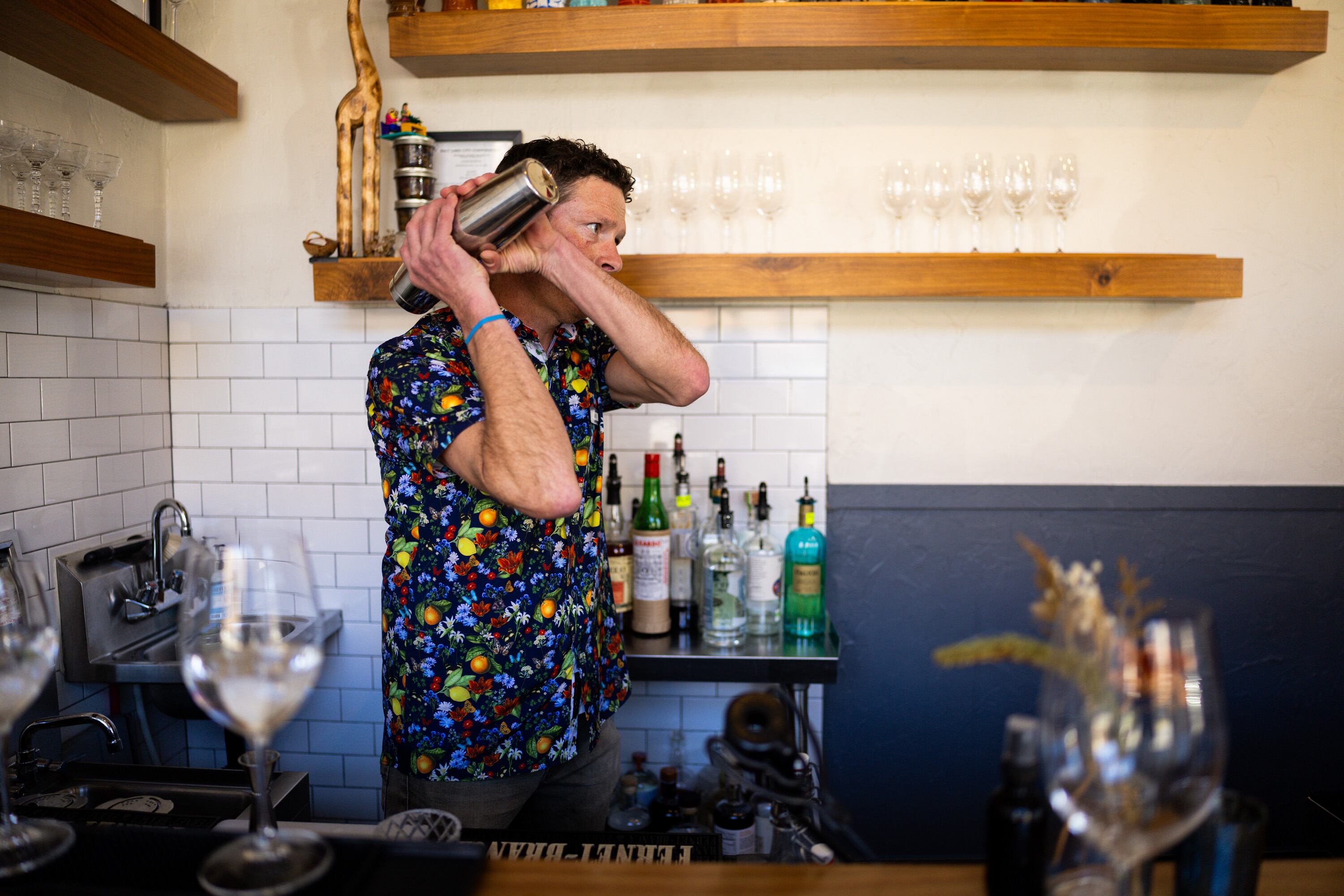 Alex Volpe makes drinks at Oquirrh Restaurant in Salt Lake City on March 19. Owner Andrew Fuller said the name of the restaurant symbolizes the small-business feel of his operation.