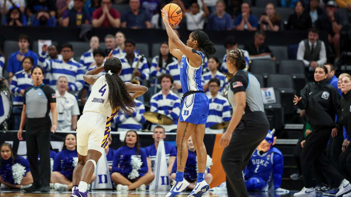 Duke guard Ashlon Jackson, center, makes a 3-pointer over LSU guard Flau'jae Johnson (4) as the clock runs out in the fourth quarter in the Sweet 16 of the NCAA college basketball tournament Friday, March 27, 2026, in Sacramento, Calif.