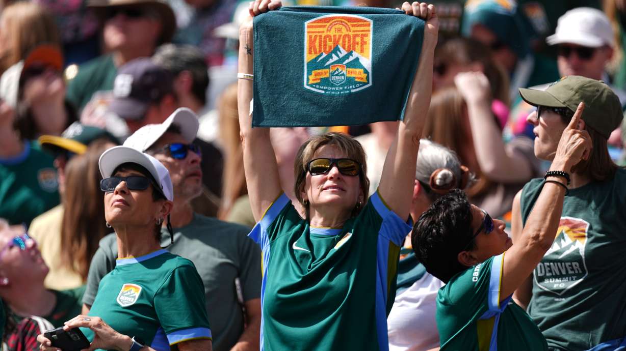 A fan holds up a towel for Denver Summit FC in the first half of an NWSL soccer match against the Washington Spirit, Saturday, March 28, 2026, in Denver.