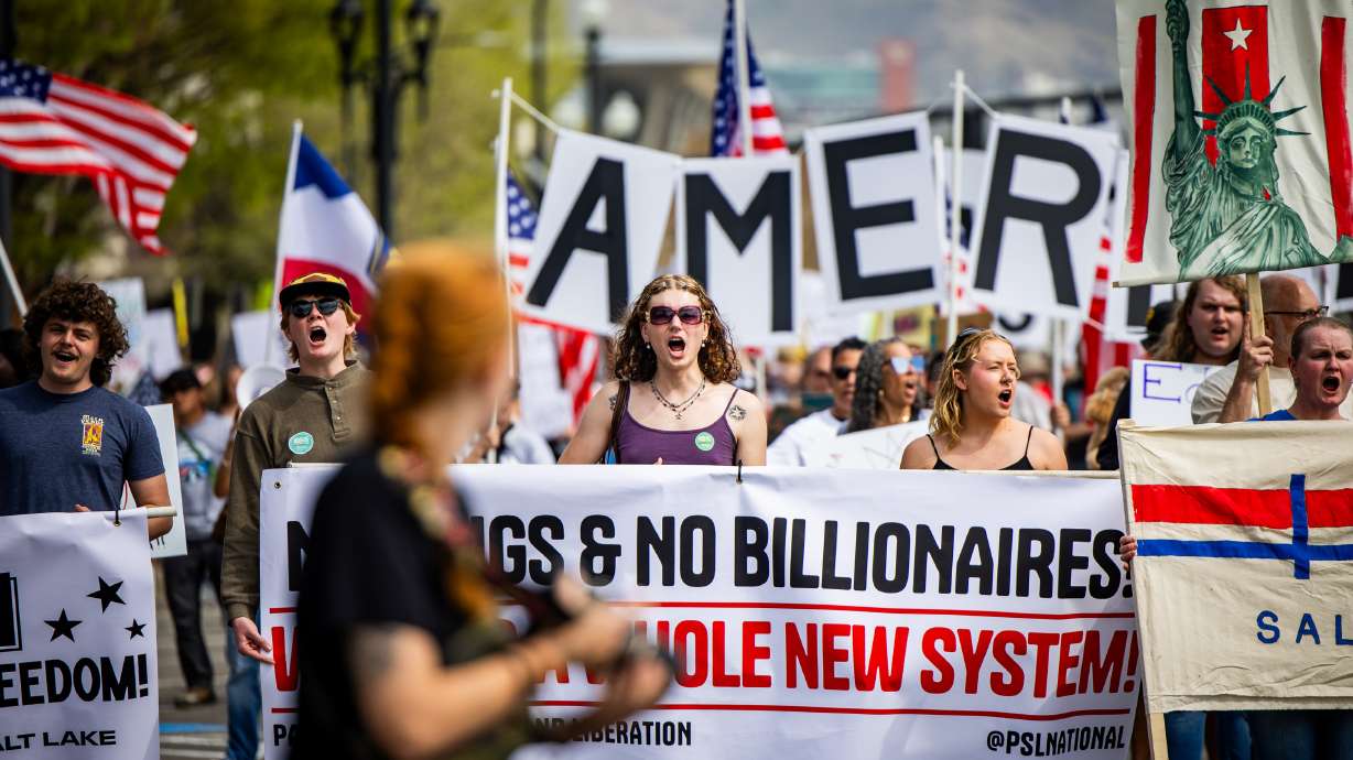 People walk from Washington Square Park to the Capitol during a “No Kings” anti-Trump protest in Salt Lake City on Saturday. The march sought to emphasize "the people's power."