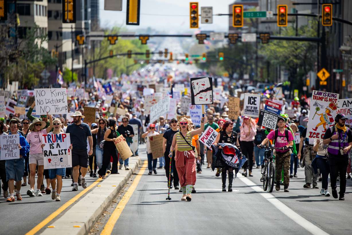 People take part in a “No Kings” anti-Trump protest where they marched from Washington Square Park to the Capitol in Salt Lake City on Saturday. The Utah Highway Patrol said about 8,000 people participated in the rally.