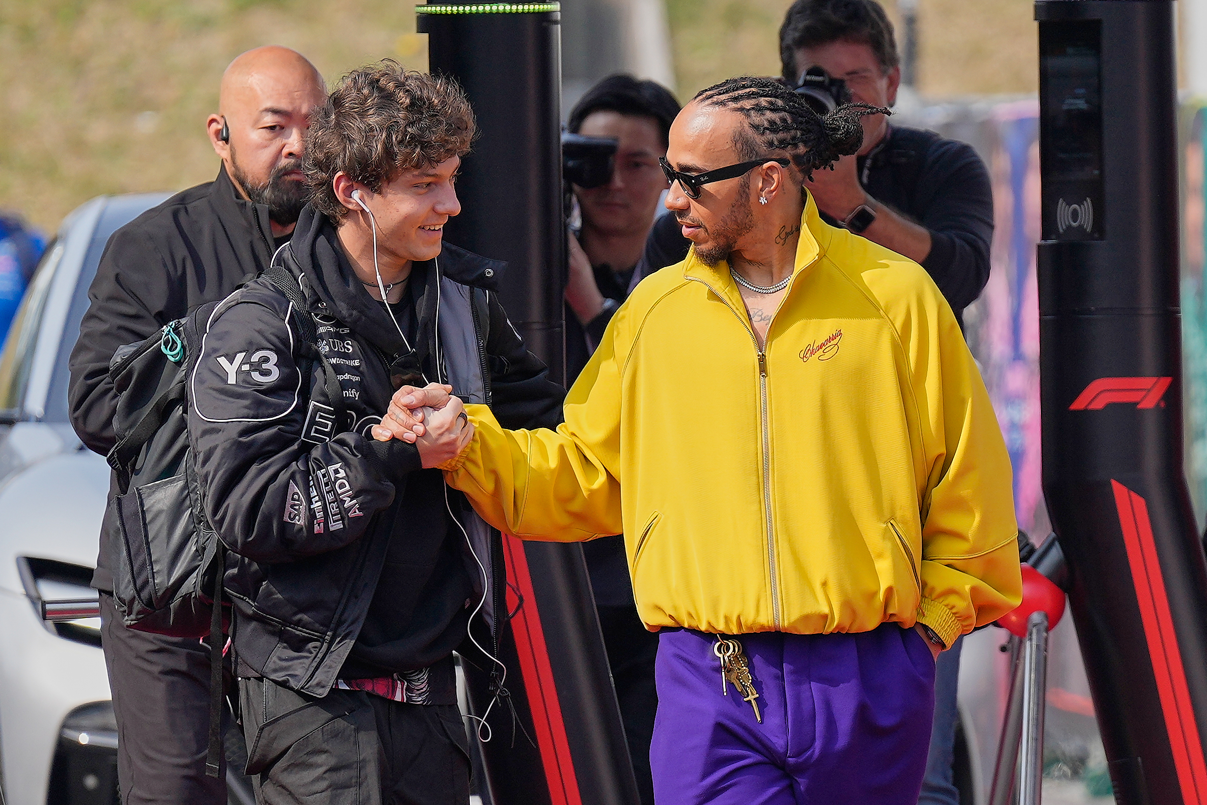 Mercedes driver Kimi Antonelli of Italy, left, and Ferrari driver Lewis Hamilton of Britain, right, greet each other prior to the Japanese Formula One Grand Prix Sunday, March 29, 2026, in Suzuka, central Japan. 