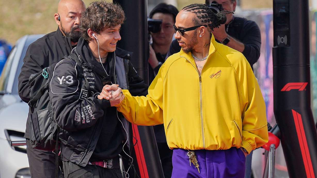 Mercedes driver Kimi Antonelli of Italy, left, and Ferrari driver Lewis Hamilton of Britain, right, greet each other prior to the Japanese Formula One Grand Prix Sunday, March 29, 2026, in Suzuka, central Japan.