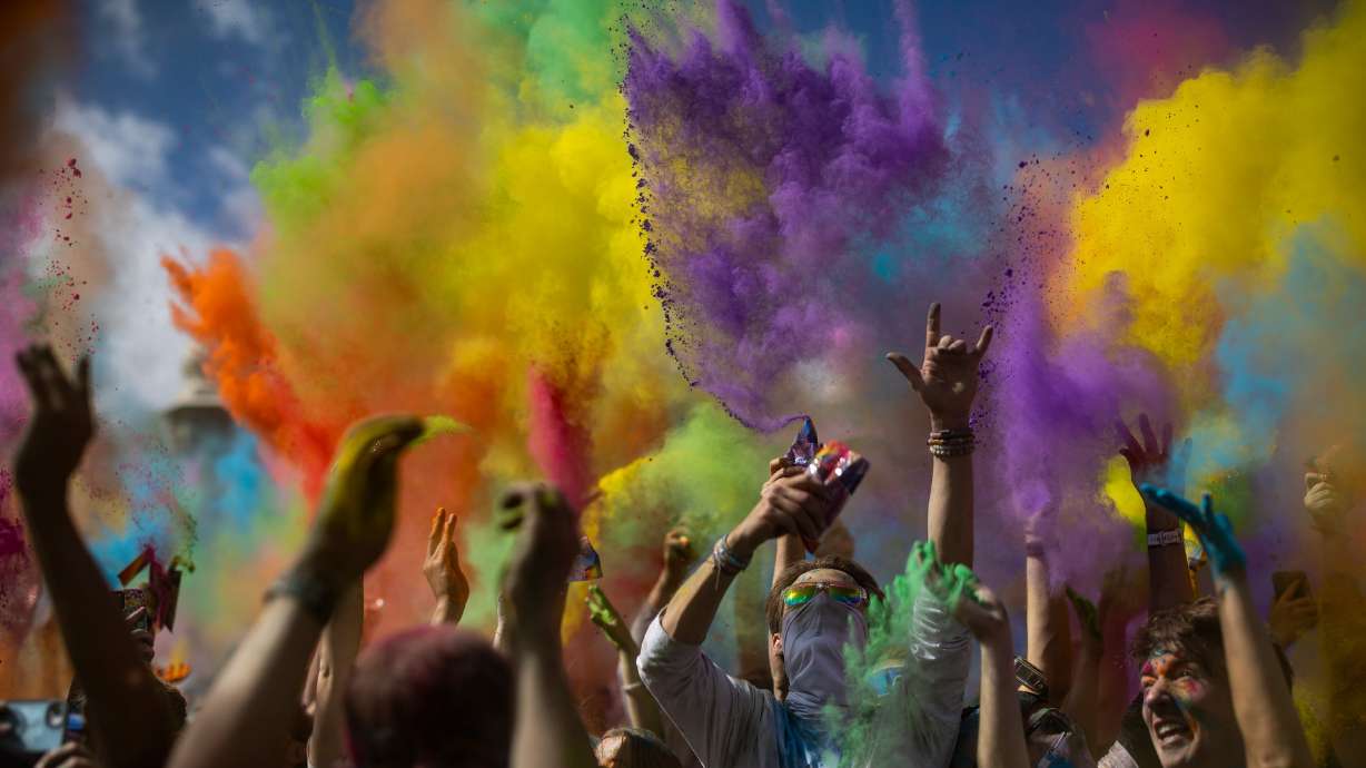 People participate in a color throw as they celebrate Holi at the Sri Sri Radha Krishna Temple in Spanish Fork on Saturday.