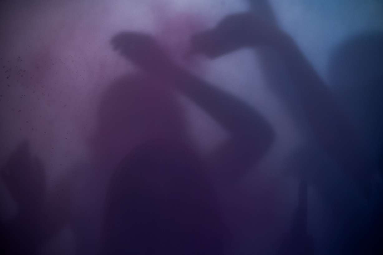 People are obscured by a cloud of colored powder as they participate in a color throw during Holi celebrations at the Sri Sri Radha Krishna Temple in Spanish Fork on Saturday.