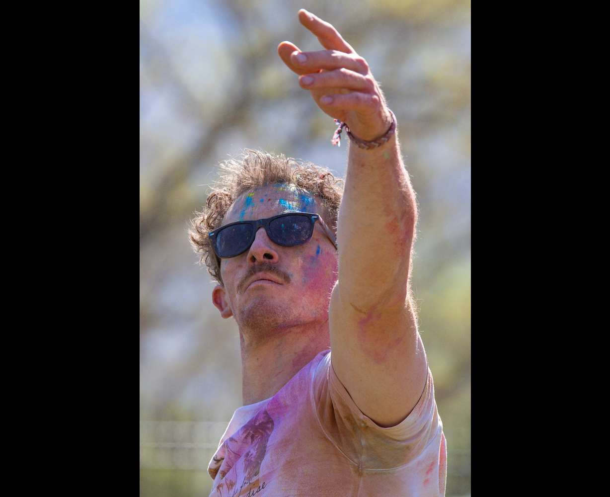 Burke Vance, of Salt Lake City, does yoga as people celebrate Holi at the Sri Sri Radha Krishna Temple in Spanish Fork on Saturday.