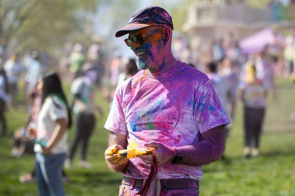 Richard Shields, of Pleasant Grove, smiles after having color dumped on him as people celebrate Holi at the Sri Sri Radha Krishna Temple in Spanish Fork on Saturday.