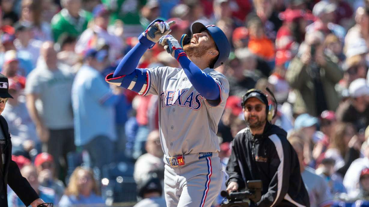 Texas Rangers' Brandon Nimmo celebrates his two run homer in the third inning of a baseball game against the Philadelphia Phillies, Sunday, March 29, 2026, in Philadelphia.