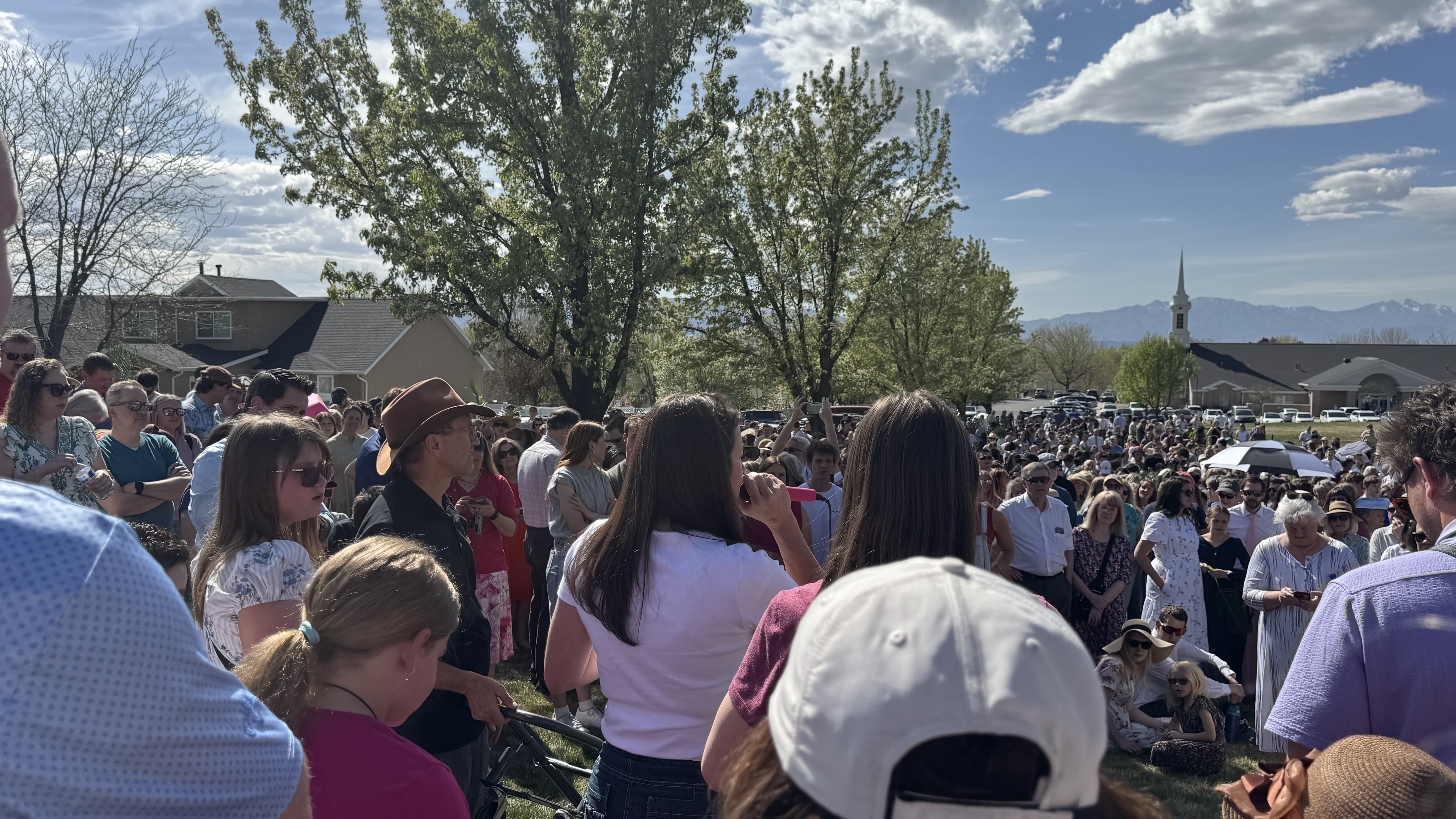 Julianne Muhlestein speaks to hundreds of people gathered ahead of a Palm Sunday walk her family hosts in Lindon on Sunday.