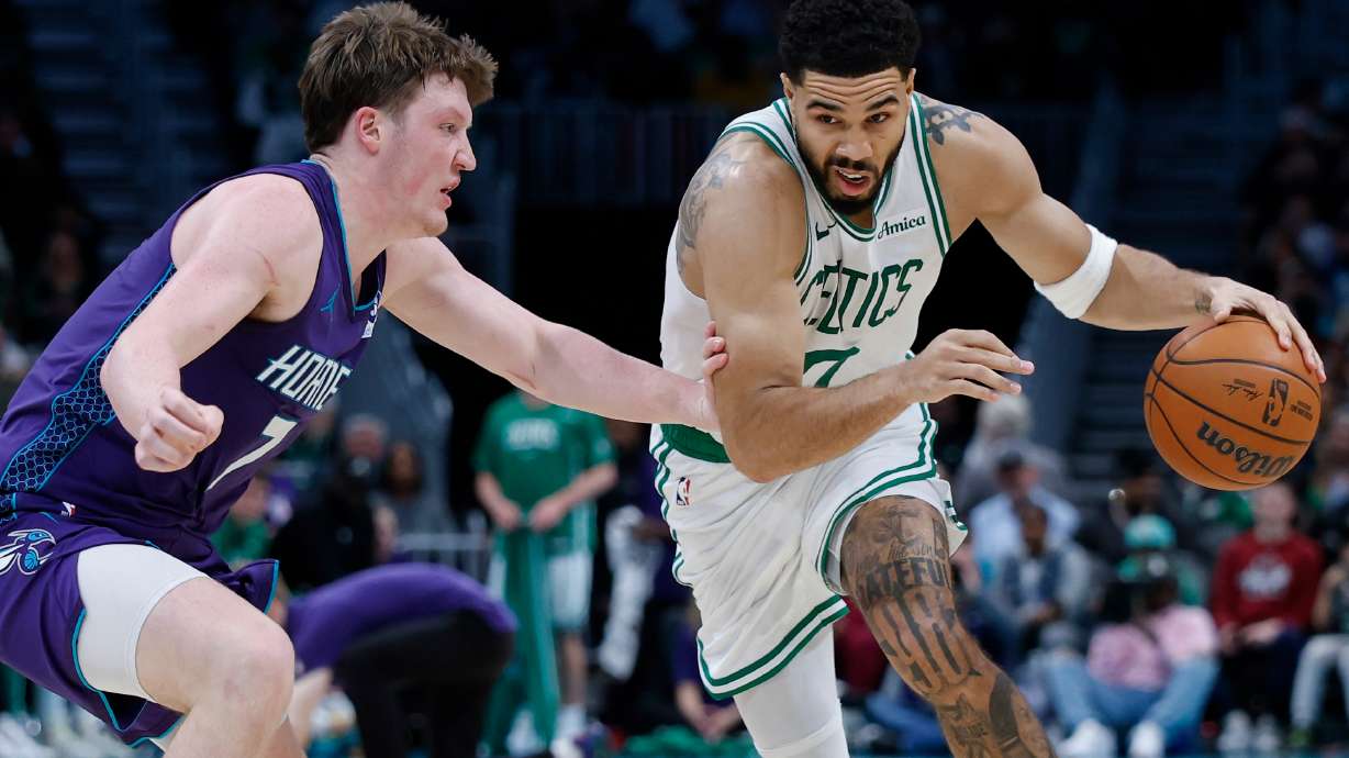 Boston Celtics forward Jayson Tatum, right, drives against Charlotte Hornets guard Kon Knueppel during the second half of an NBA basketball game in Charlotte, N.C., Sunday, March 29, 2026.