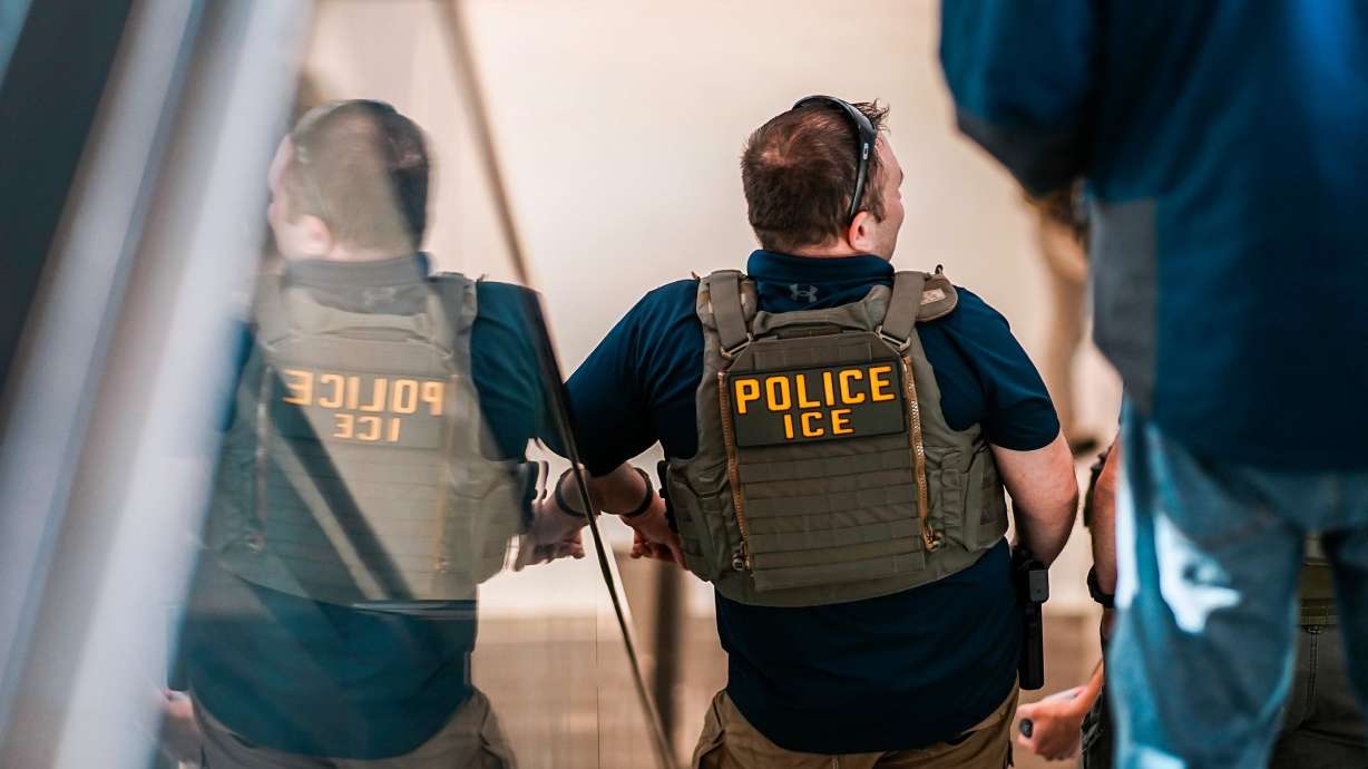 Federal immigration agents walk through Terminal A at Newark International Airport in New Jersey, Tuesday. Utah Sen. Mike Lee is demanding congressional leaders bring lawmakers back early from its ongoing two-week recess.
