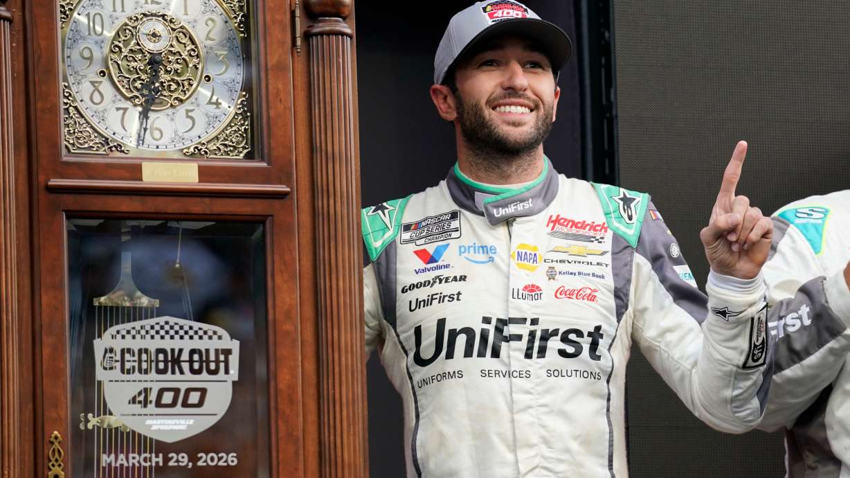 Chase Elliott poses with the trophy in Victory Lane after winning a NASCAR Cup Series auto race in Martinsville, Va., Sunday, March 29, 2026.