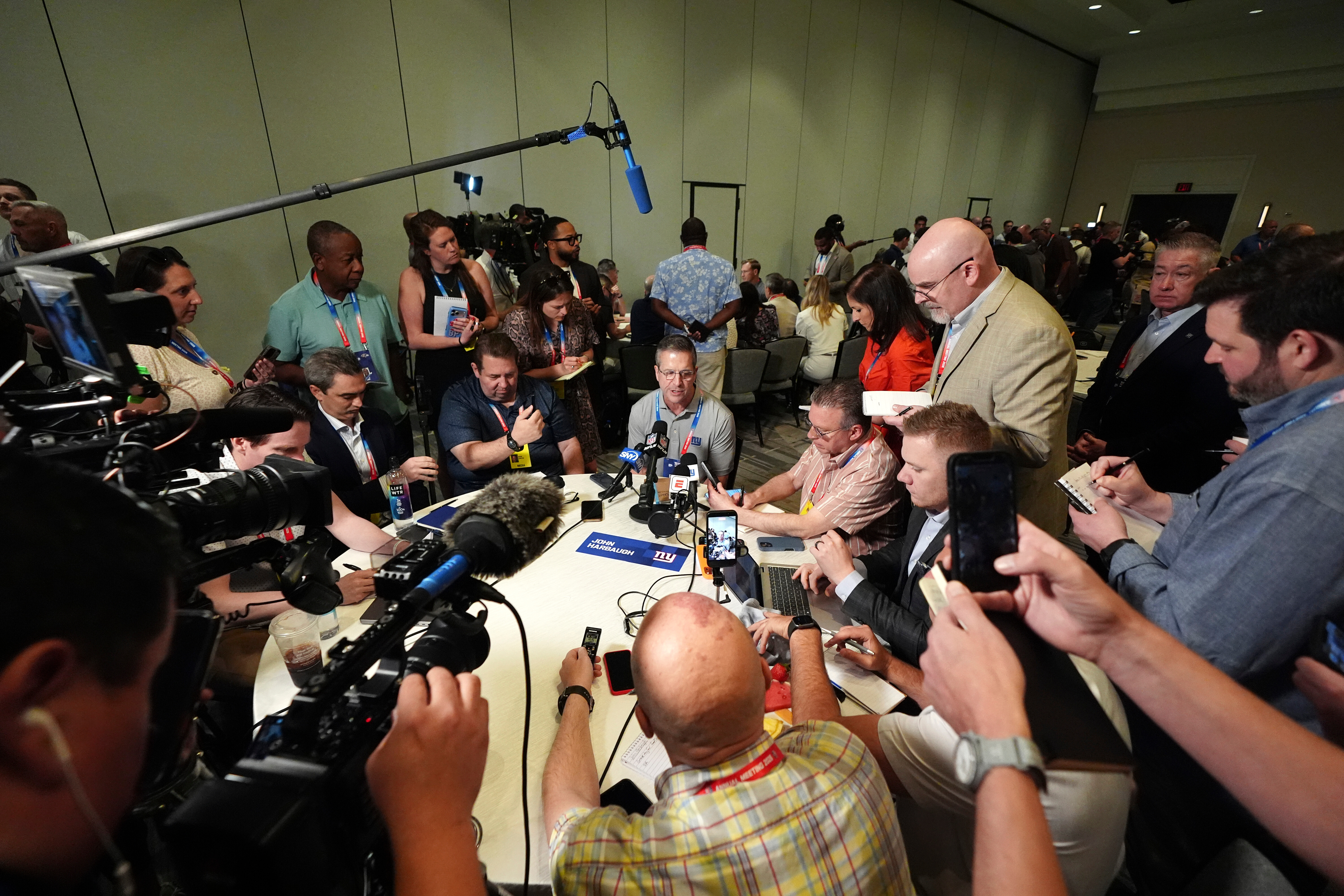 New York Giants head coach John Harbaugh talks with reporters at the annual NFL football meetings, Monday, March 30, 2026, in Phoenix. 