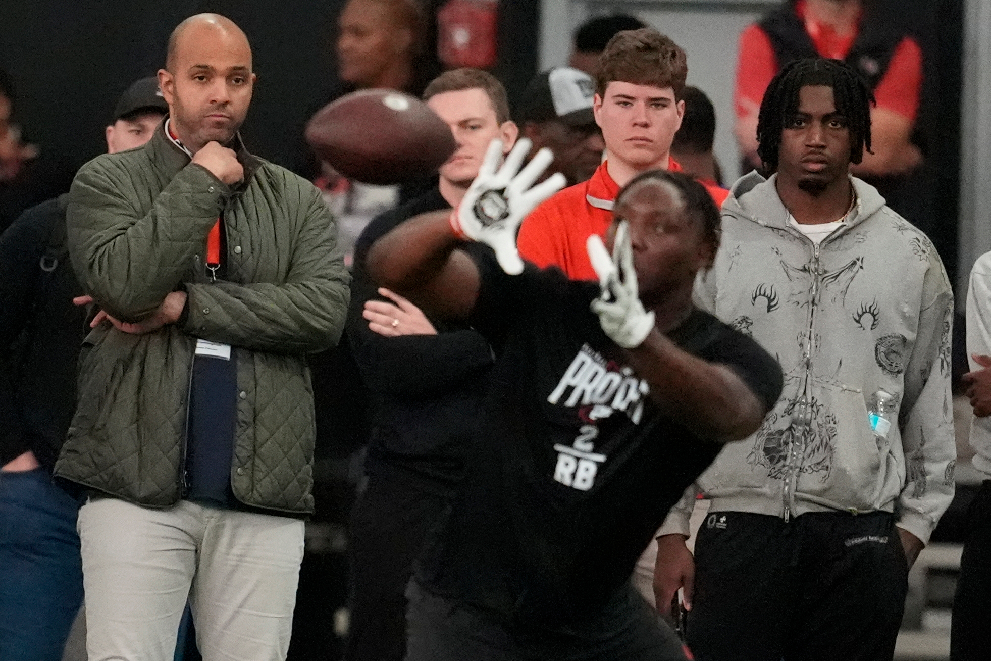 Ian Cunningham, general manager of the Atlanta Falcons, left, watches players work out during the school's NFL football pro day, Wednesday, March 18, 2026, in Athens, Ga. 