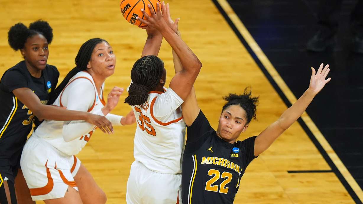 Texas forward Madison Booker (35) shoots on Michigan forward Kendall Dudley (22) during the first half in the Elite Eight of the NCAA college basketball tournament, Monday, March 30, 2026, in Fort Worth, Texas.