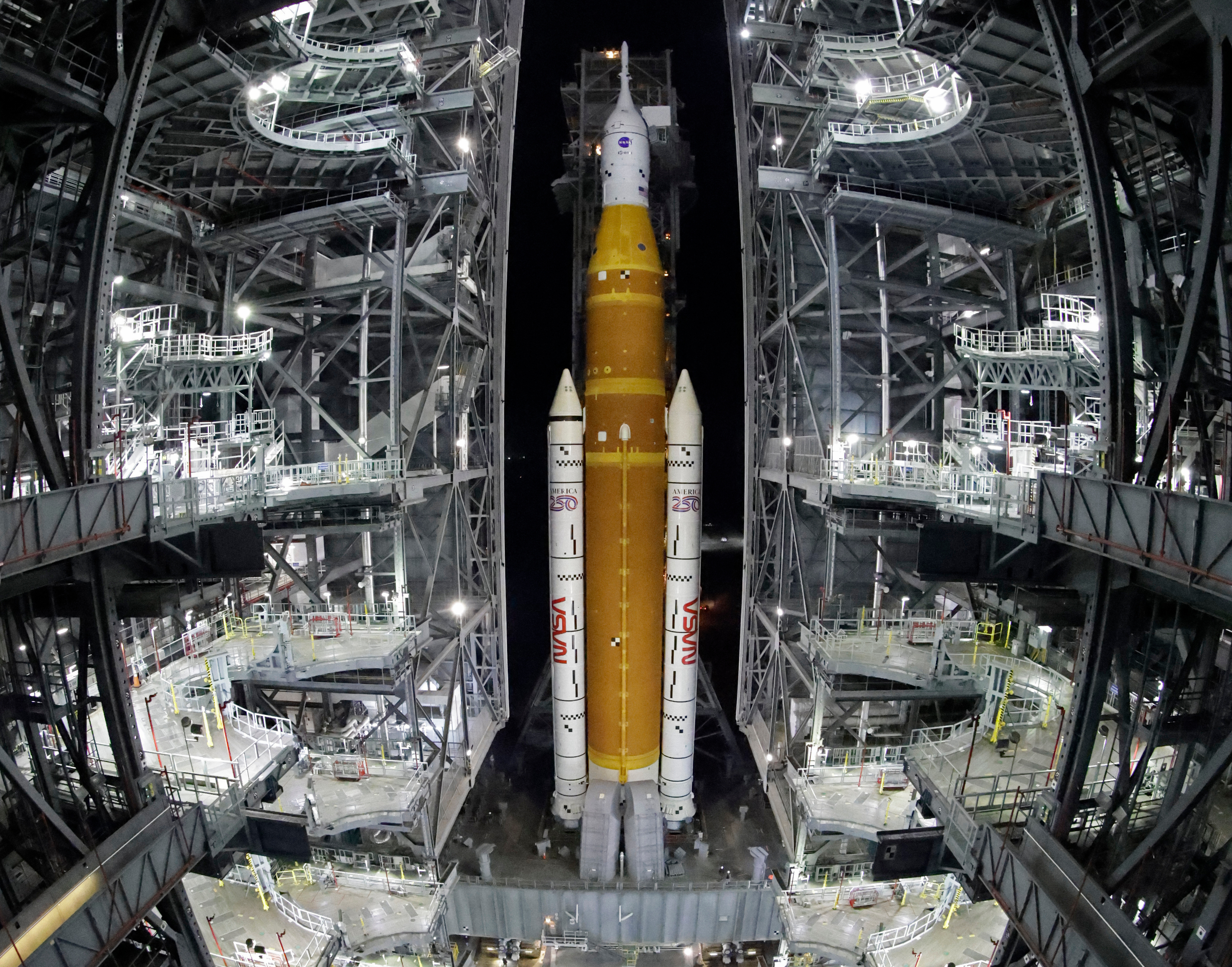 The NASA Artemis II rocket, with the Orion spacecraft aboard, leaves the Vehicle Assembly Building at the Kennedy Space Center in Cape Canaveral, Fla., March 20.