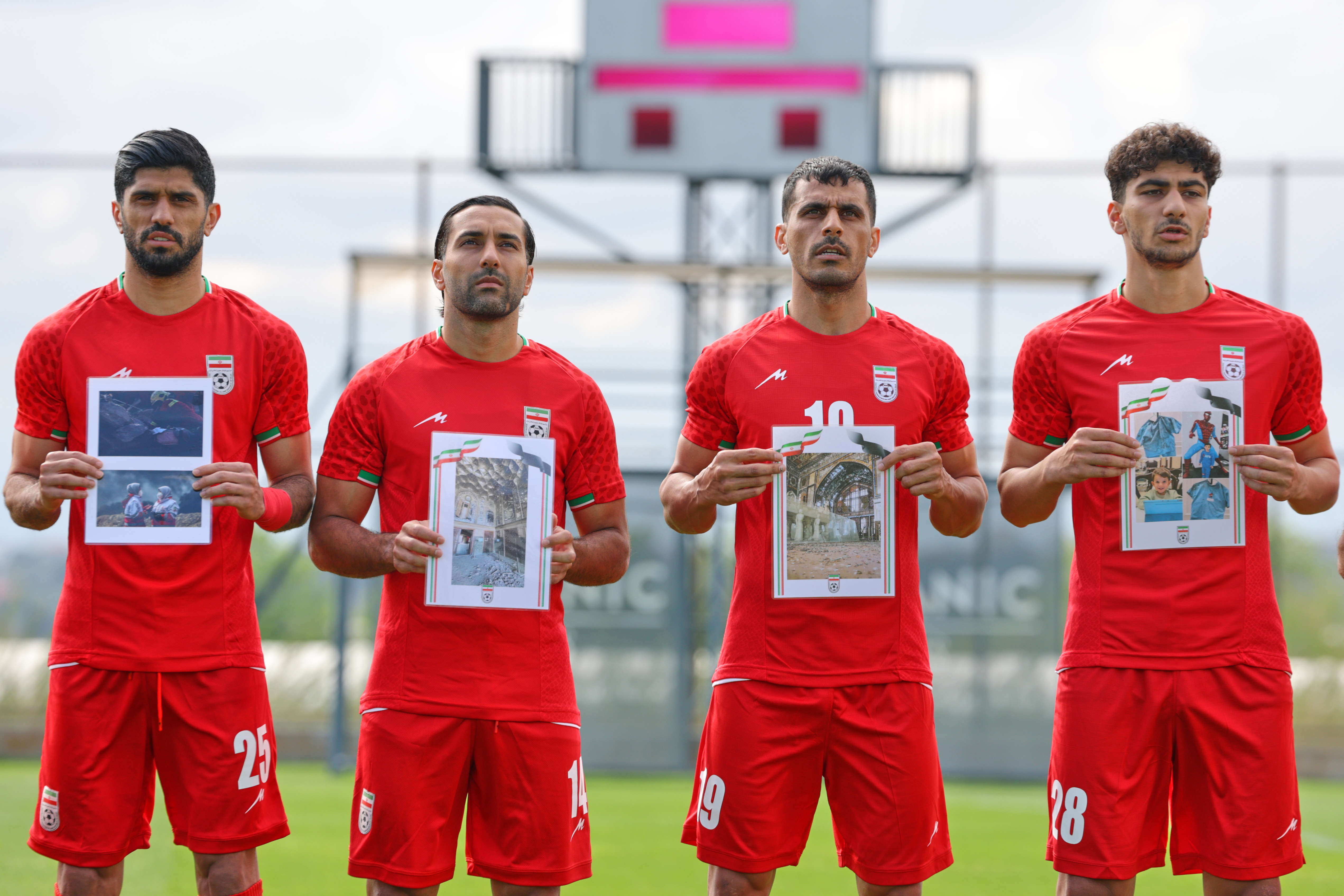 Iran's players sing the national anthem, holding pictures of children allegedly killed in U.S. and Israel strikes in Iran, before a friendly soccer match between Iran and Costa Rica, in Antalya, southern Turkey, Tuesday, March 31, 2026. 