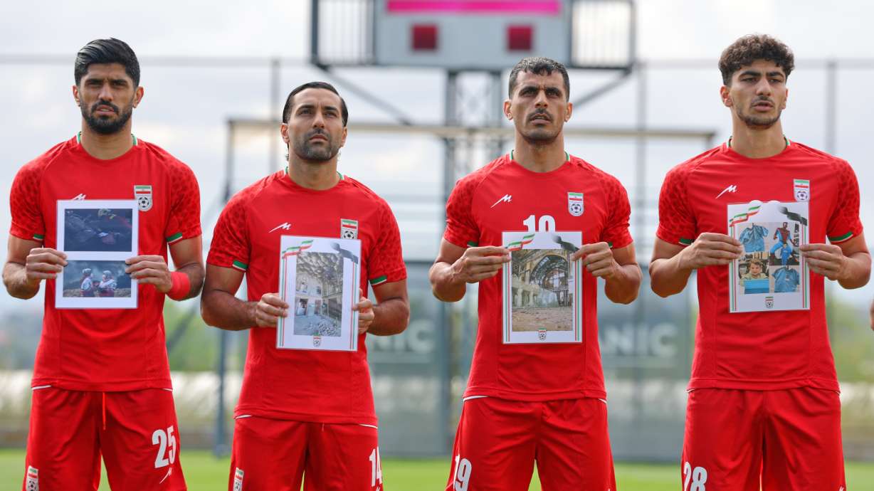 Iran's players sing the national anthem, holding pictures of children allegedly killed in U.S. and Israel strikes in Iran, before a friendly soccer match between Iran and Costa Rica, in Antalya, southern Turkey, Tuesday, March 31, 2026.