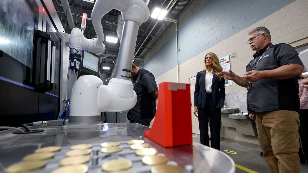 Troy Winchester, Davis Technical College lead machining instructor, shows Kelly Loeffler, the 28th administrator of the Small Business Administration a 4-axis CNC machining center with a robotic arm as she tours Davis Technical College in Kaysville on May 13. Rep. Mike Kennedy introduced legislation this week to help technical colleges get the federal aid they need.