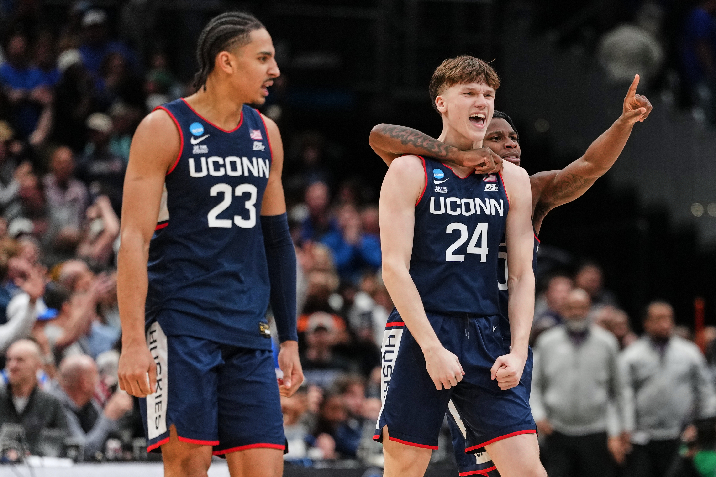 UConn guard Braylon Mullins (24) reacts with teammates after scoring the winning basket against Duke in the Elite Eight of the NCAA college basketball tournament, Sunday, March 29, 2026, in Washington.