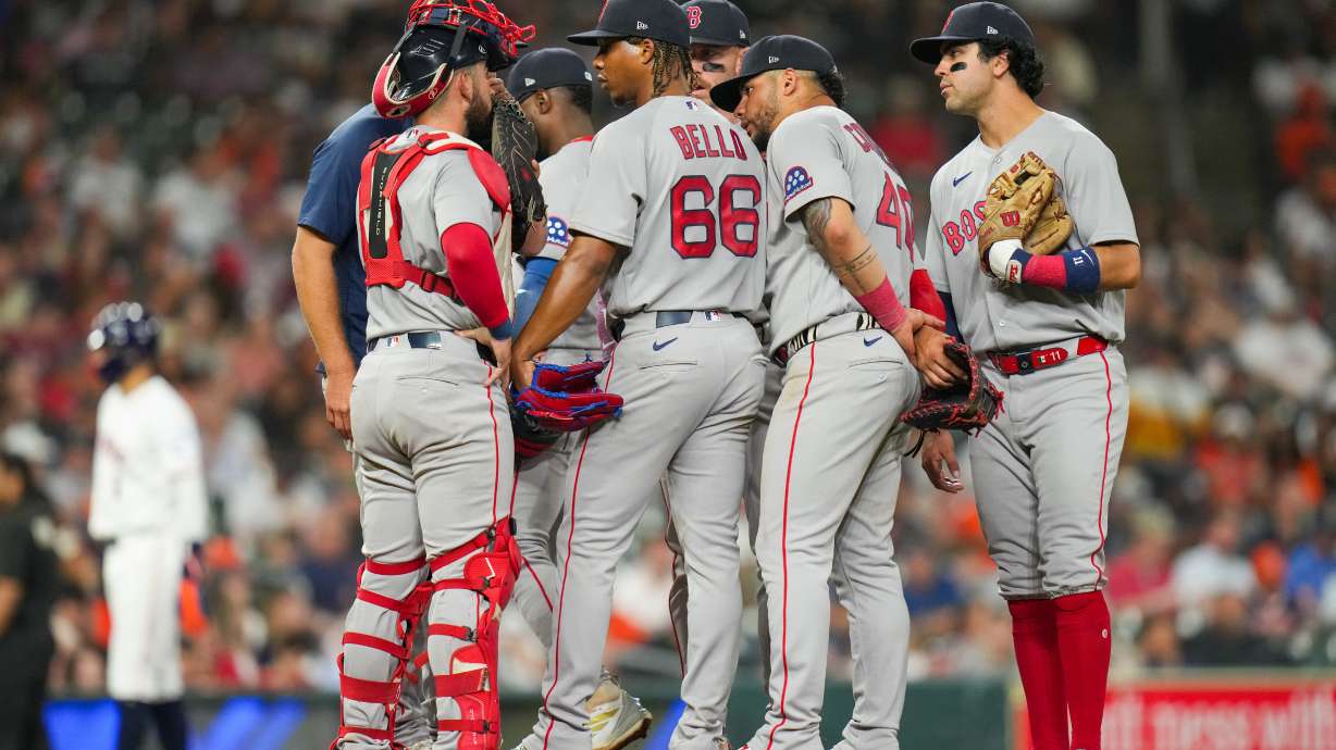 Boston Red Sox starting pitcher Brayan Bello (66) talks with teammates during a mound visit in the fifth inning of a baseball game against the Houston Astros in Houston, Tuesday, March 31, 2026.