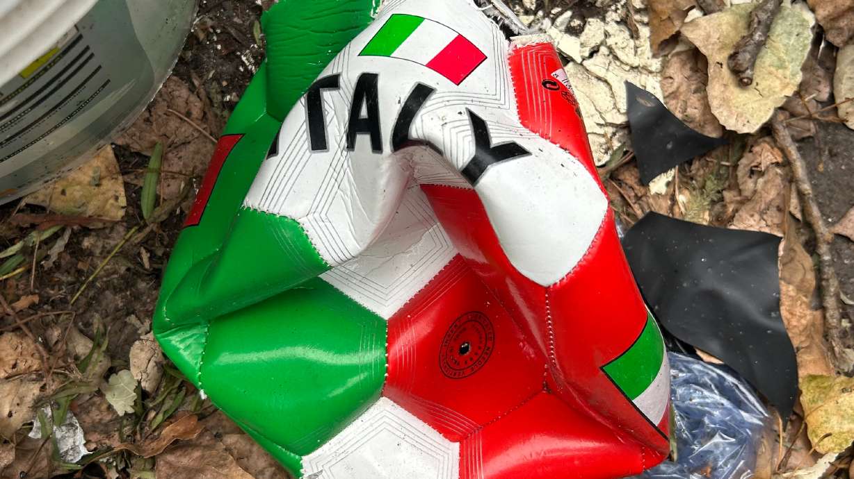 A broken soccer ball is pictured on a street in Rome, Wednesday, April 1, 2026.