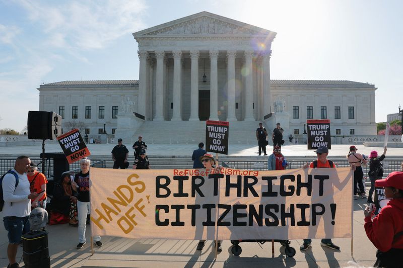 Demonstrators hold signs outside the Supreme Court on the day the court is expected to hear oral arguments on the legality of the Trump administration's effort to limit birthright citizenship for the children of immigrants, in Washington, Wednesday. Solicitor General D. John Sauer argued birthright citizenship demeans its value.
