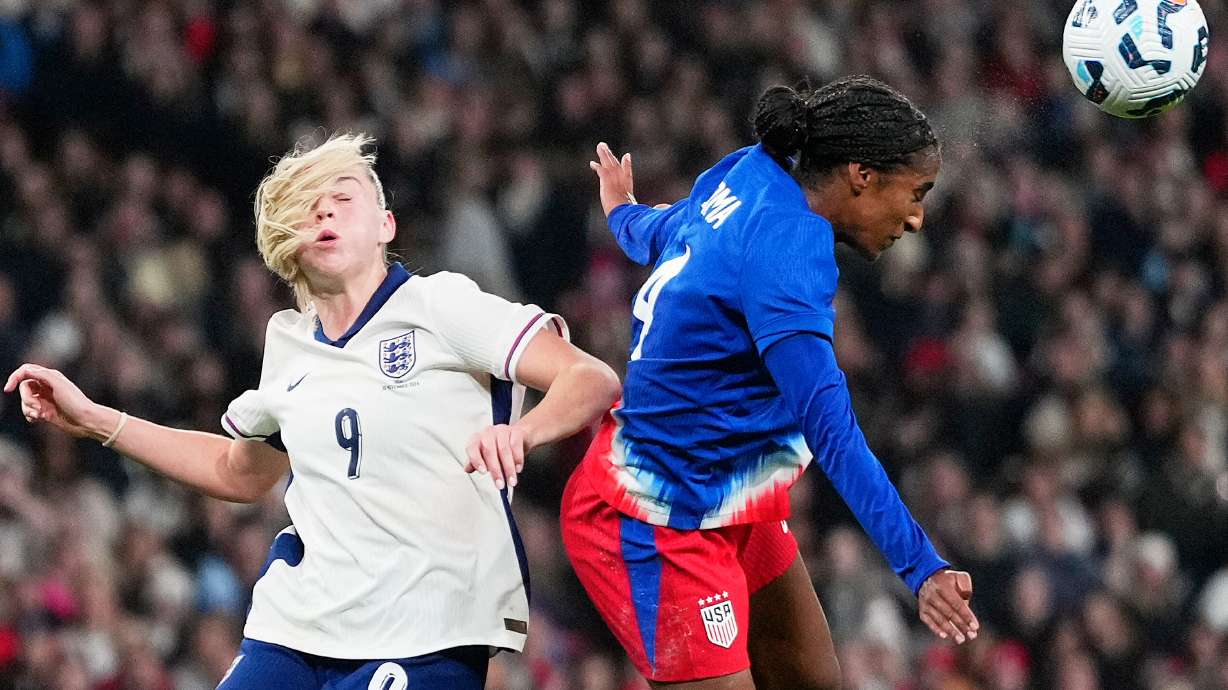 FILE - England's Alessia Russo and United States' Naomi Girma challenge for the ball during the International friendly women soccer match between England and United States at Wembley stadium in London, Nov. 30, 2024.