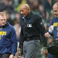 Umpire C.B. Bucknor leaves Rays-Brewers game after foul tip strikes him in his face mask