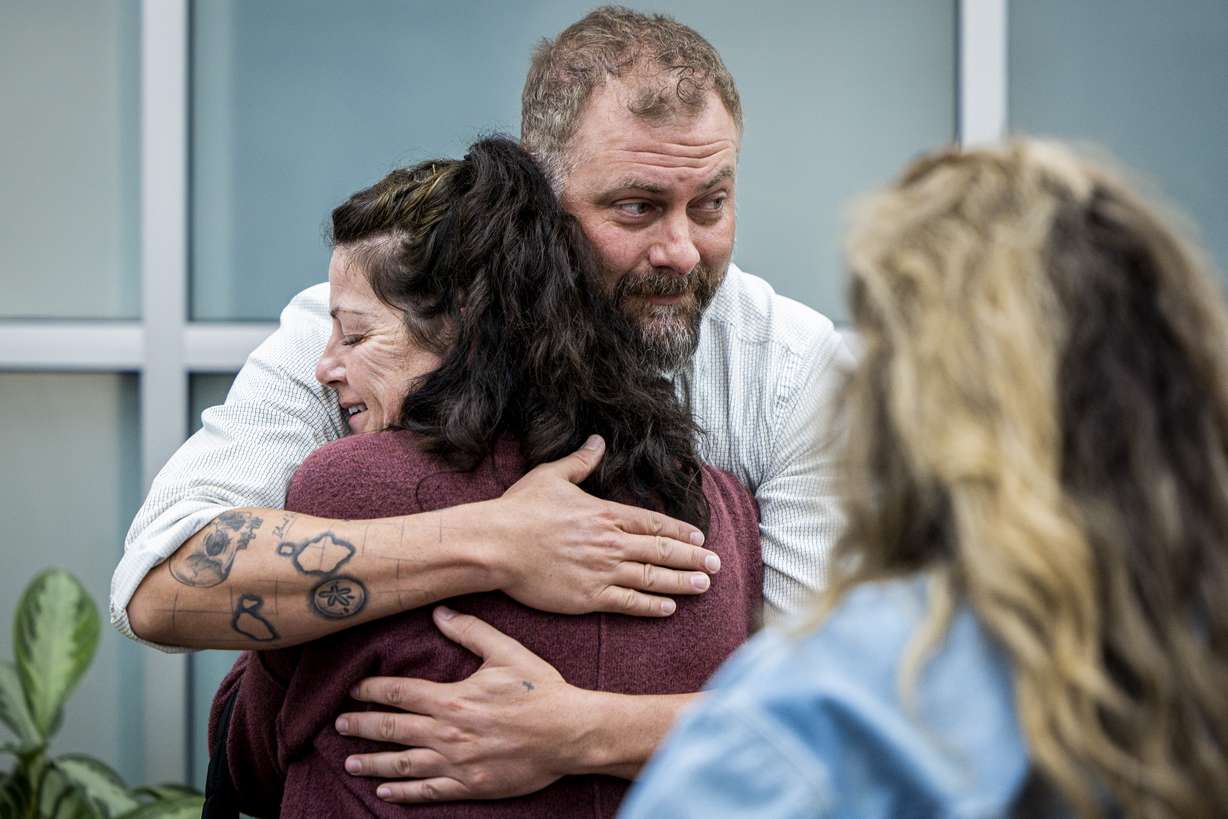 Utah County sheriff's detective Jake Hall looks to other family members as he hugs Tommi Aime, youngest sister of Laura Aime, after a press conference announcing definitive evidence has been found that Ted Bundy murdered Laura Ann Aime in 1974, held at the Utah County Sheriff's Office in Spanish Fork on Wednesday.