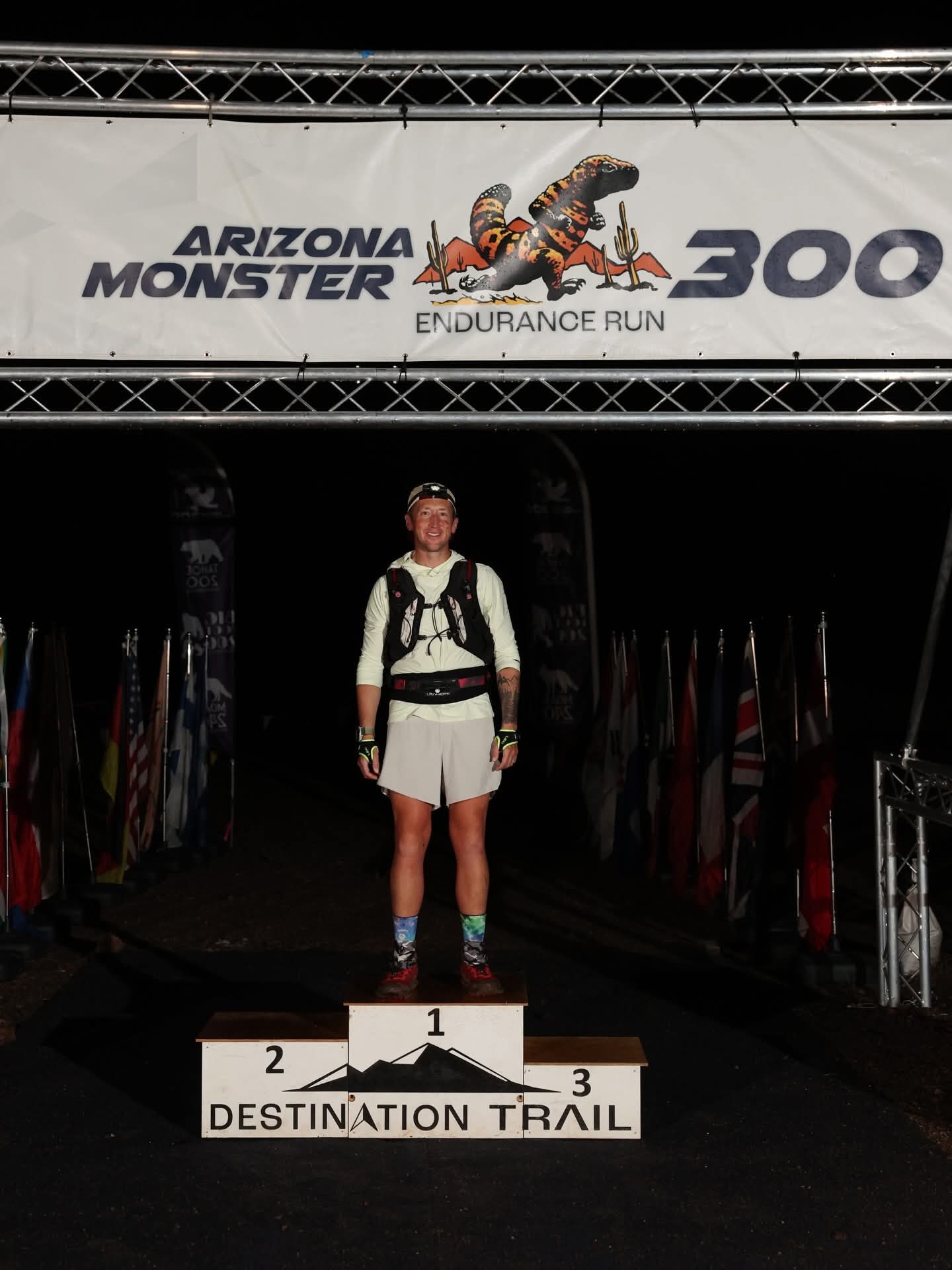Michael McKnight stands alone on the podium after finishing the Arizona Monster 300 in record-time. A Utah native, McKnight overcame both mental and physical hurdles to break the record for the 304-mile race through the Sonoran Desert.