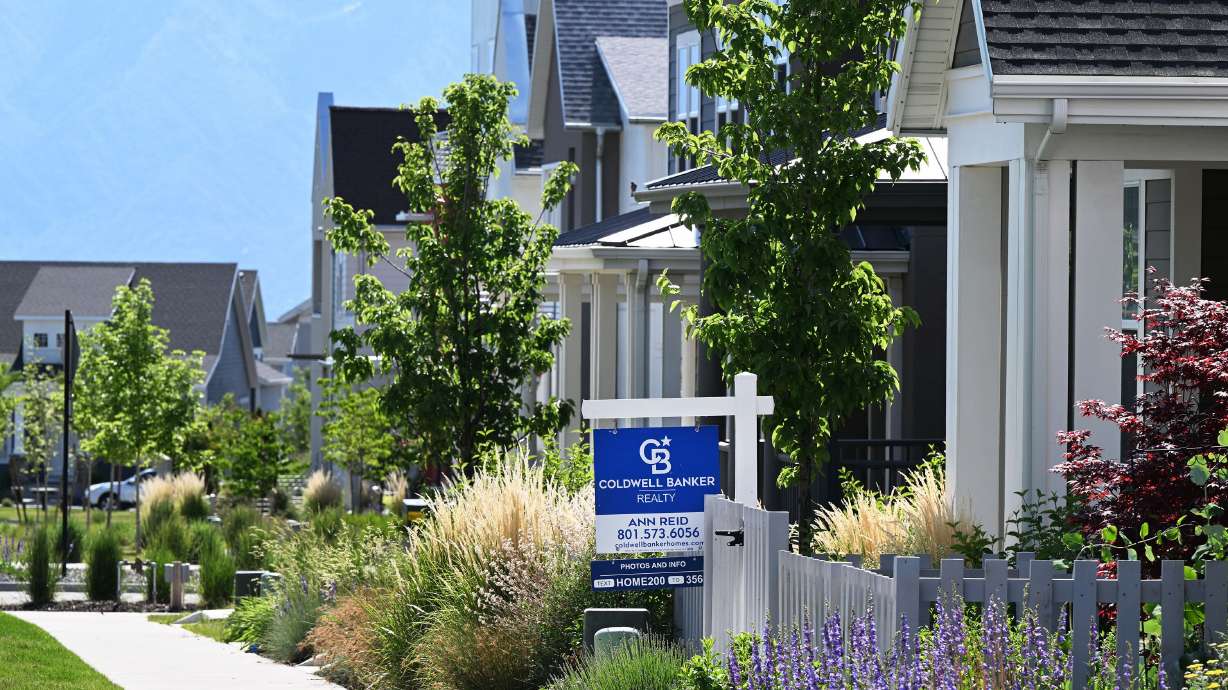 A real estate sign is posted near a home in West Jordan, on June 3. Redfin says there's nearly $700 billion in unsold houses on the market nationwide, a record high.