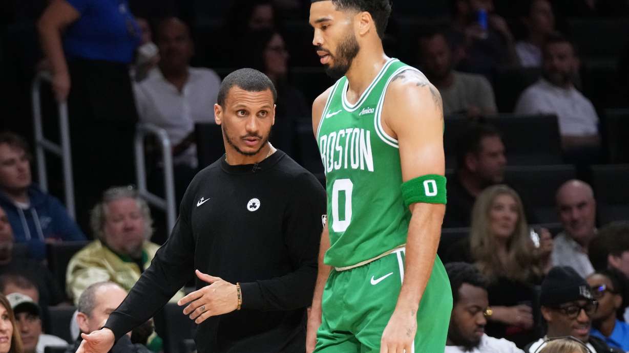 Boston Celtics head coach Joe Mazzulla, left talks with forward Jayson Tatum (0) during the first half of an NBA basketball game against the Miami Heat, Wednesday, April 1, 2026, in Miami.