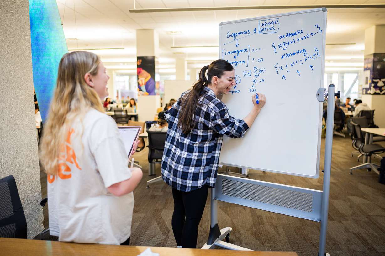 University of Utah student Jadyn Littlefield, 23, left, is tutored by University of Utah student Sarah Heywood, 33, right, at the J. Willard Marriott Library in Salt Lake City on Wednesday.
