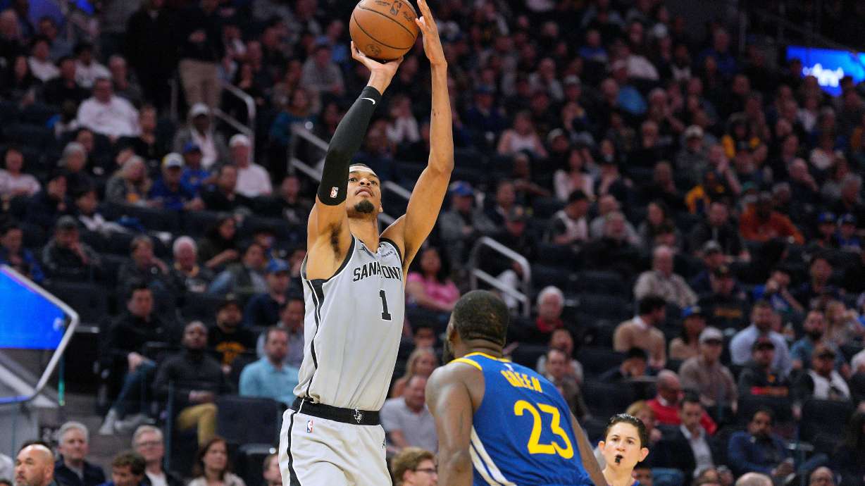 San Antonio Spurs forward Victor Wembanyama (1) takes a shot over Golden State Warriors forward Draymond Green (23) during the first half of an NBA basketball game in San Francisco, Wednesday, April 1, 2026.