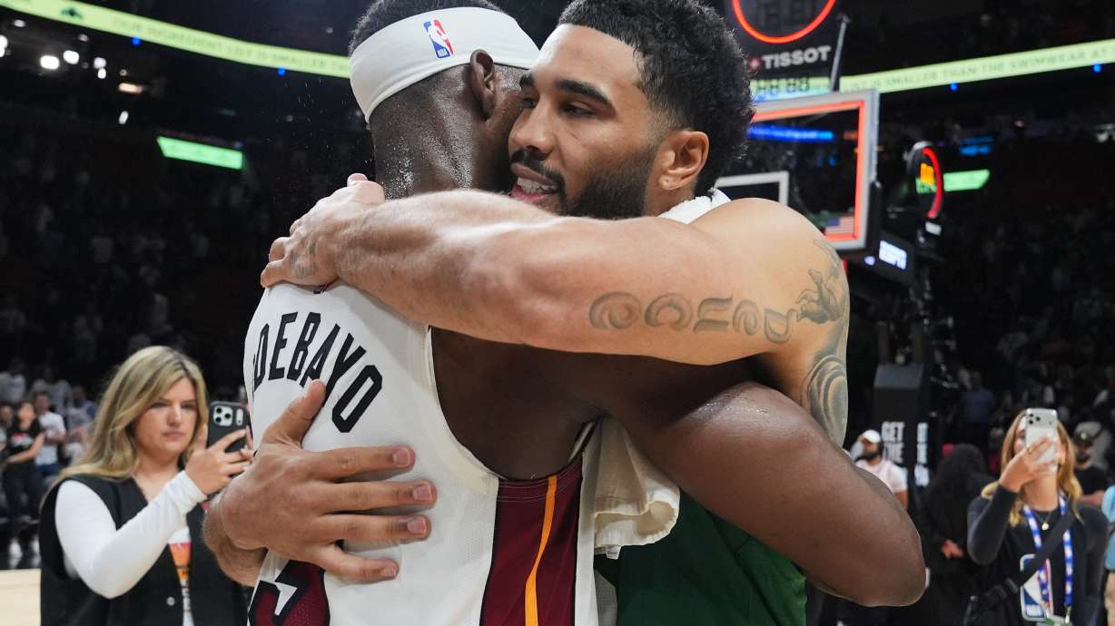 Miami Heat center Bam Adebayo (13) and Boston Celtics forward Jayson Tatum, right, embrace after an NBA basketball game, Wednesday, April 1, 2026, in Miami.