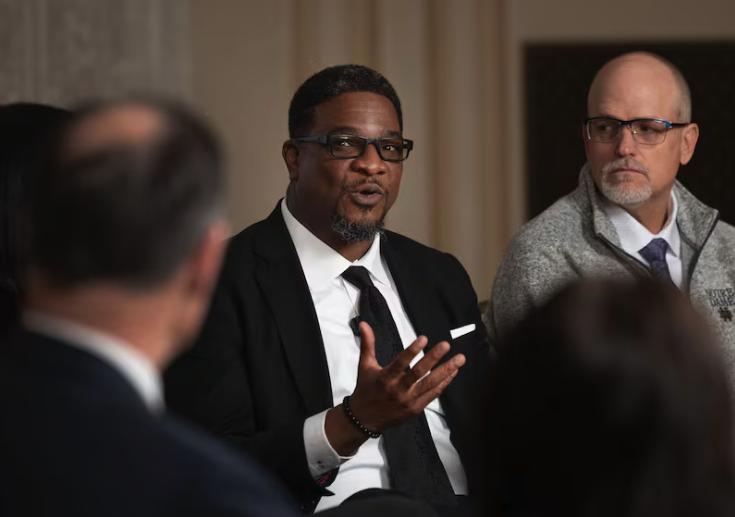 Corey J. Hodges, lead pastor at The Point Church, speaks at Pamela Atkinson’s humanitarian roundtable at the Thomas S. Monson Center in Salt Lake City on Wednesday. Michael Edwards, right, listens.