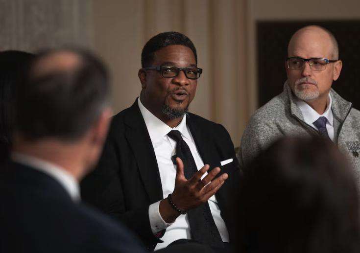 Corey J. Hodges, lead pastor at The Point Church, speaks at Pamela Atkinson’s humanitarian roundtable at the Thomas S. Monson Center in Salt Lake City on Wednesday. Michael Edwards, right, listens.