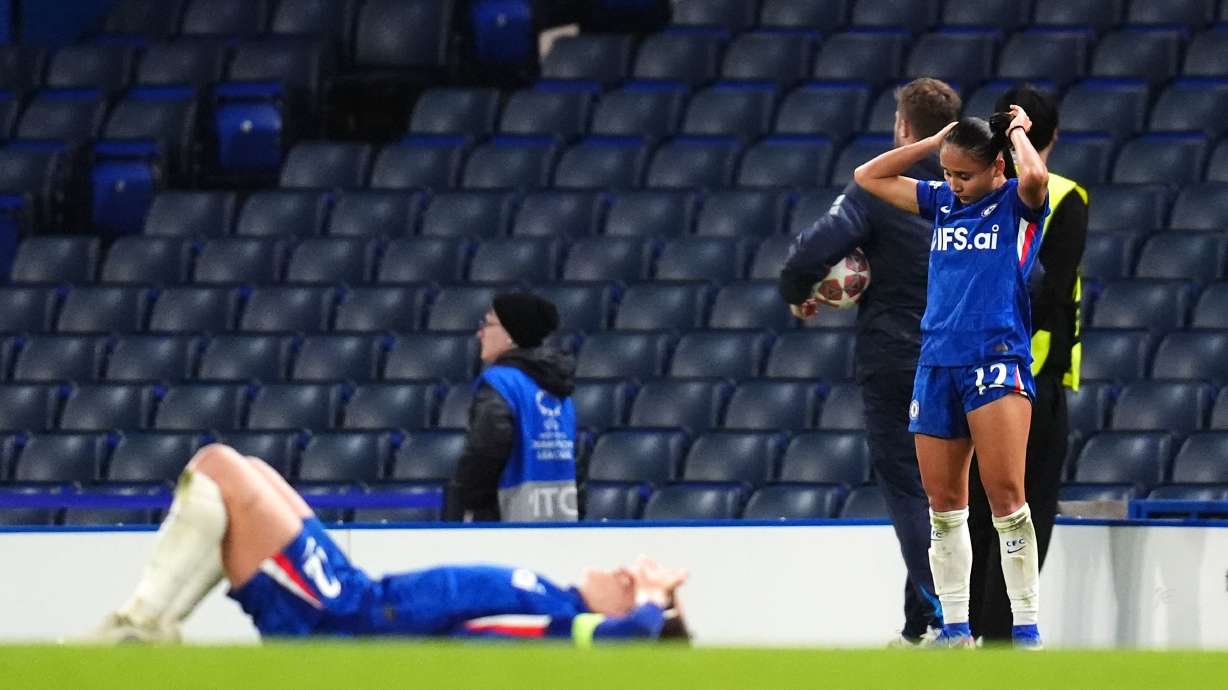 Chelsea's Alyssa Thompson, right, and a teammate react following defeat in the Women's Champions League quarterfinal second leg soccer match against Arsenal in London, Wednesday, April 1, 2026.