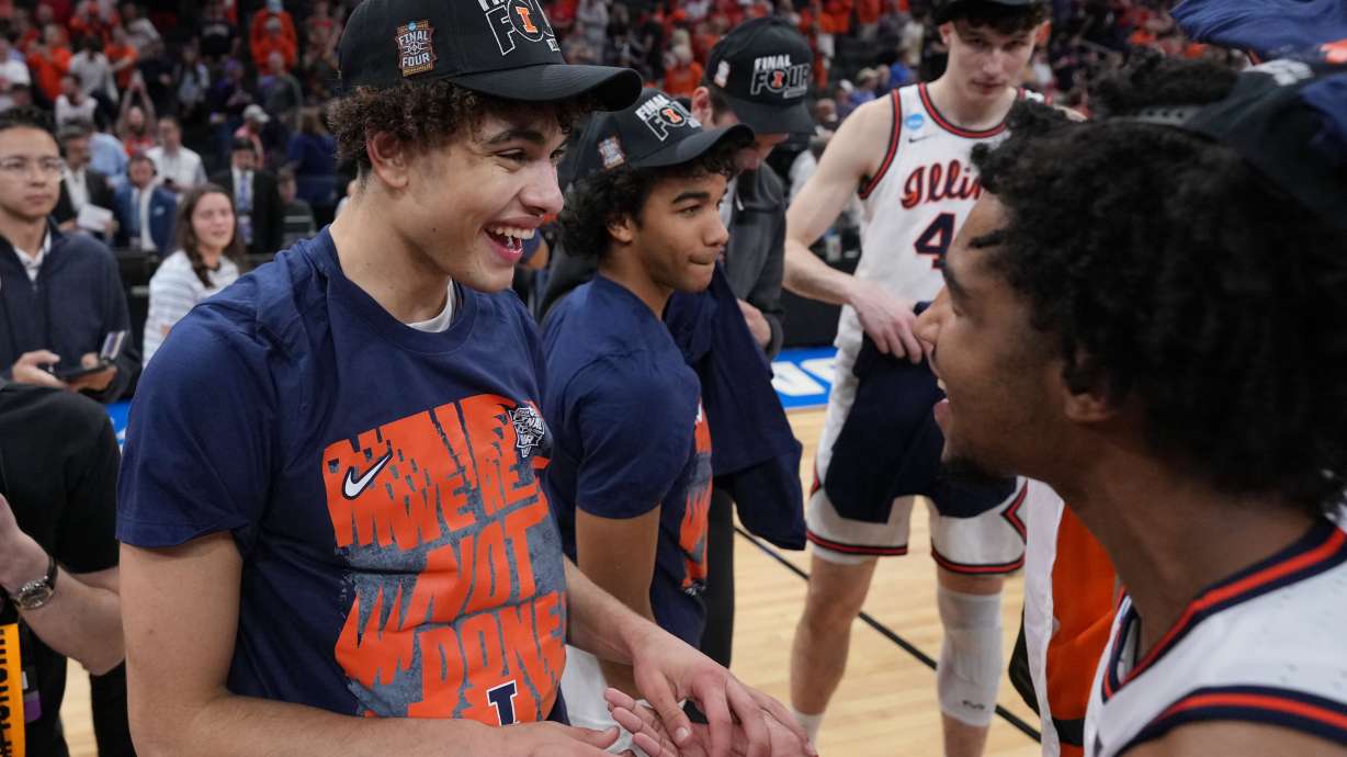 Illinois' Keaton Wagler, left, celebrates with a teammate after Illinois beat Iowa in an Elite Eight game in the NCAA college basketball tournament Saturday, March 28, 2026, in Houston.